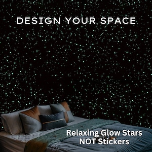 May include: A bedroom scene with a dark wall covered in glowing green stars. The text "DESIGN YOUR SPACE" is at the top, and "Relaxing Glow Stars NOT Stickers" is at the bottom. A bed with pillows and a comforter is in the foreground.