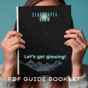 May include: A PDF guide booklet with a black cover featuring a starry night sky design. The text "STARSCAPES GLOW" and "Let's get glowing!" are in a glowing teal color. The bottom of the cover shows a mountain range.
