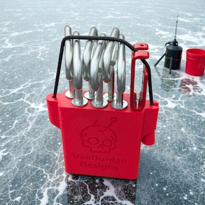 May include: A red fishing tool with multiple silver metal rods and a black handle. The tool has a skull logo and the text "VanDurdan Designs" on the front. A small fishing rod and bucket are in the background.