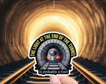 May include: A sticker with a train in a tunnel and the text "The light at the end of the tunnel is probably a train".