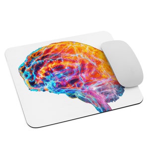 May include: A colourful abstract brain design mouse mat with a white mouse on top.