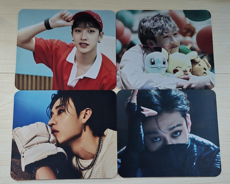 May include: Set of four square mouse pads featuring images of a person in various poses. The images include a person wearing a red shirt and cap, holding plush toys, and posing with a serious expression.
