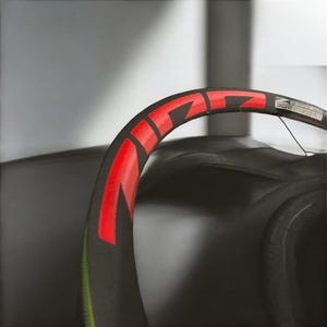May include: A black bicycle wheel with a red rim and the word "ZIPP" printed in red on the rim.