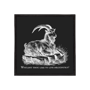 May include: Black square patch featuring a white illustration of a goat resting on a rock. The goat has large curved horns and long, shaggy fur. The text "WOULDST THOU LIKE TO LIVE DELICIOUSLY?" is below the goat.