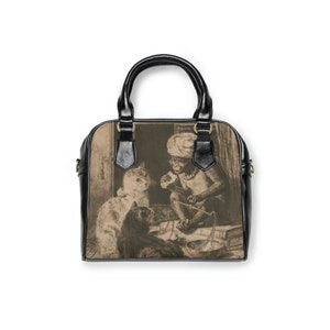 May include: A black leather handbag with a vintage illustration of a monkey, a cat, and a dog. The monkey is holding a scale and a stick. The cat and dog are looking at the monkey.
