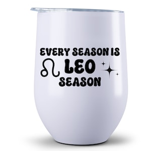 May include: White stainless steel wine tumbler with black text that reads "Every season is Leo season" with a Leo zodiac symbol and stars.