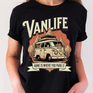 May include: Black t-shirt with a vintage-style illustration of a camper van with the text "Vanlife" and "Home is where you park it".