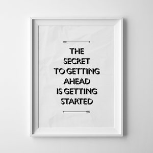 May include: Black and white motivational quote print in a white frame. The quote reads "The secret to getting ahead is getting started."