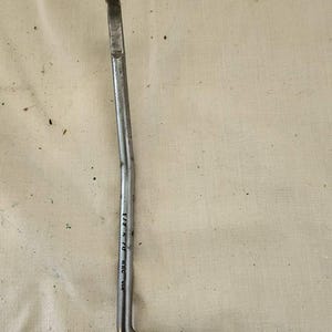 May include: A silver wrench with a 1 1/2 inch opening and the text "DYK-C-US8" on the handle.