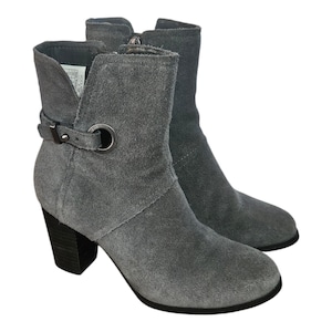 May include: A set of three ceramic mugs with a speckled, matte finish. The mugs are in shades of cream, light gray, and dark gray. Each mug has a simple, minimalist design, perfect for coffee or tea.