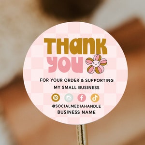 May include: Pink and white checkered circle sticker with the text "THANK YOU" in gold and pink lettering. The sticker also includes a pink and brown flower with a smiley face. The text "FOR YOUR ORDER & SUPPORTING MY SMALL BUSINESS" is in black text. Below the text are icons for Pinterest, Instagram, Facebook, and TikTok. The text "@SOCIALMEDIAHANDLE BUSINESS NAME" is in black text.