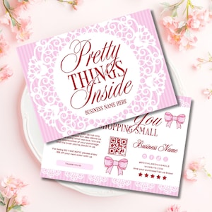 May include: Two pink and white business cards with floral and lace designs. The front card reads "Pretty Things Inside" with space for a business name. The back card says "Thank you for shopping small" with a QR code and social media handles.