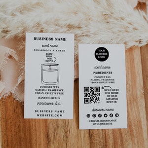 May include: Two white business cards with black text. The left card features a candle illustration and the text "BUSINESS NAME", "scent name", "CEDARWOOD & AMBER", "SNIFF HERE FOR SCENT", "COCONUT WAX NATURAL FRAGRANCE VEGAN-CRUELTY FREE HANDPOURED IN vancouver, b.c.", "BUSINESS NAME WEBSITE.COM". The right card features a QR code, the text "YOUR BUSINESS LOGO", "scent name", "INGREDIENTS COCONUT WAX NATURAL FRAGRANCE VEGAN-CRUELTY FREE", "SCAN HERE FOR MORE OF OUR AMAZING SCENTS", "business name", "@SOCIALMEDIAHANDLE @YOURWEBSITE".