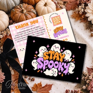 May include: Two rectangular thank you cards with a Halloween theme. One card features a pink gingham pattern, text, and a QR code. The other card has a black background with white cartoon ghosts and the orange and purple text Stay Spooky.