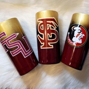 May include: Three stainless steel tumblers with a gold and maroon ombre finish. Each tumbler features a different Florida State Seminoles logo.