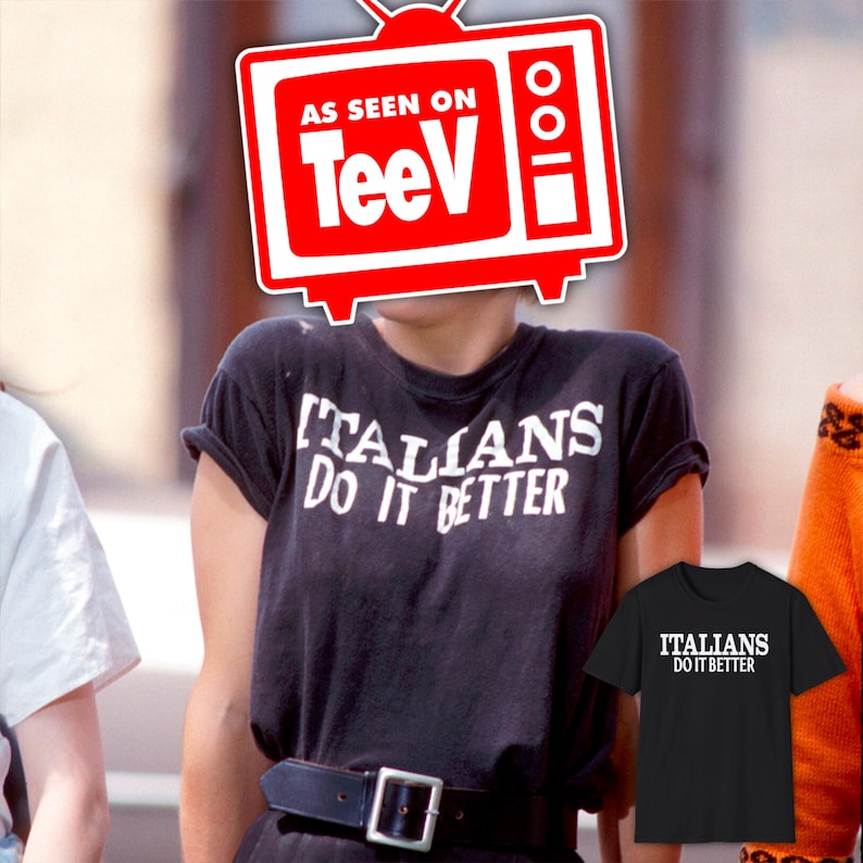 May include: A black t-shirt with white text that reads "Italians Do It Better". The shirt is being worn by a person. A television screen with the words "As Seen On TeeVi" is superimposed over the person's face. A second black t-shirt with the same text is shown on the right side of the image.
