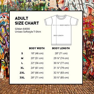 May include: Adult unisex t-shirt size chart with measurements in inches and centimeters. The chart shows the body width and body length for sizes S, M, L, XL, 2XL, and 3XL.
