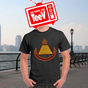 May include: A black t-shirt with a graphic of an all-seeing eye inside a pyramid with the text "Novus Ordo Seclorum" and "MDCCLXXVI" underneath.
