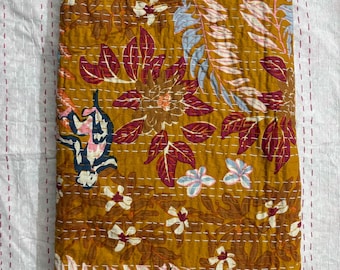 May include: A mustard yellow kantha quilt with a floral pattern in shades of pink, red, blue, and white. The quilt is made of cotton and has a hand-stitched design.