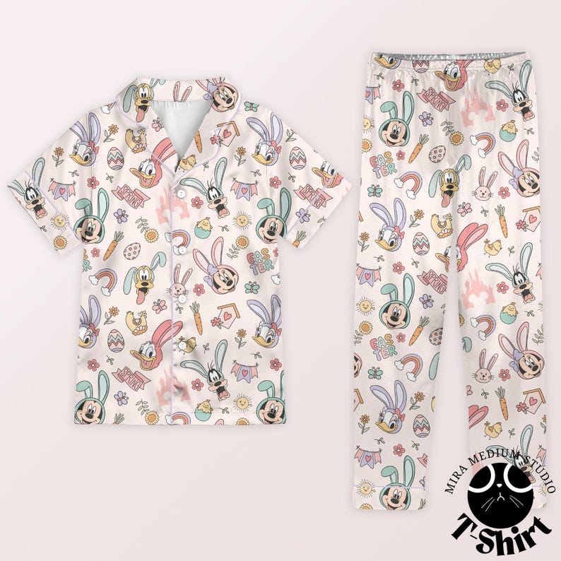 May include: A two-piece pajama set featuring a light beige background with an all-over print of cartoon characters, Easter eggs, carrots, and rainbows. The short-sleeved top and pants are decorated with Mickey Mouse, Donald Duck, and other Disney characters.