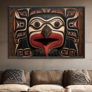 May include: A close-up of a carved wooden totem pole featuring a red, black and white design. The totem pole depicts a bird with a large beak and eyes.