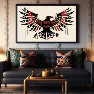 May include: A black leather sofa with two cushions featuring geometric patterns in orange, black and white. A framed print of a stylised black and red eagle with spread wings hangs above the sofa. A wooden side table with a lamp sits to the left of the sofa.