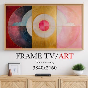 Op de afbeelding: Een ingelijst abstract schilderij met een cirkelvormig ontwerp in het midden. Het schilderij is verdeeld in vier secties, elk met een andere kleur: rood, blauw, geel en roze. Het schilderij is getiteld "The Frame" en heeft een resolutie van 3840x2160.