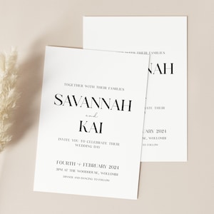 May include: A wedding invitation with a minimalist design. The invitation is printed on white cardstock and features black text. The text reads "Together with their families, Savannah and Kai invite you to celebrate their wedding day, Fourth February 2024, 3pm at The Woodhouse, Wollombi. Dinner and dancing to follow."