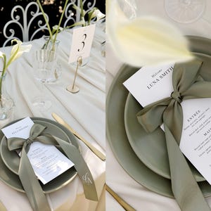 May include: A wedding table setting with a green and white color scheme. The table is set with a white tablecloth, green plates, and white napkins. There is a green ribbon tied around the menu card, which says "Welcome Luna Smith".