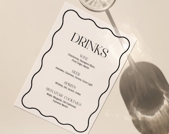 May include: A white card with a black border and the word "DRINKS" in large, bold letters. The card lists different types of drinks, including wine, beer, spirits, and signature cocktails.