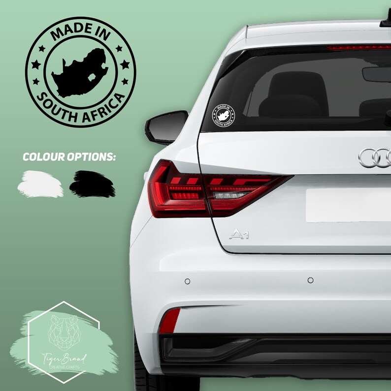 May include: A white car with a black "Made in South Africa" sticker on the back window. The sticker features a map of South Africa and stars around the border. The sticker is available in black or white.