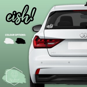 May include: A white car with a black "eish!" sticker on the back window. The sticker is available in black or white.
