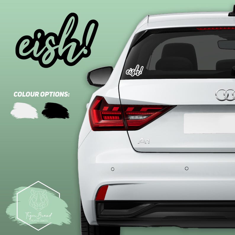 May include: A white car with a black "eish!" sticker on the back window. The sticker is available in black or white.