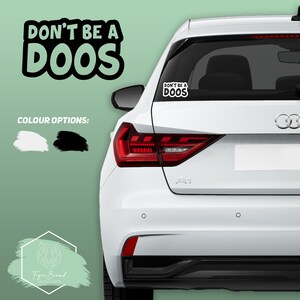 May include: White car with a black "Don't be a Doos" sticker on the back window. The sticker is also available in white.