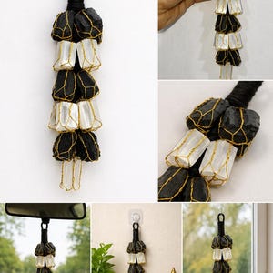 May include: A hanging decorative item featuring alternating black and white stones, encased in gold-colored wire. The item is suspended from a black cord loop. The image includes text that reads "CAR HANGING", "WALL HANGING", and "WINDOW HANGING".
