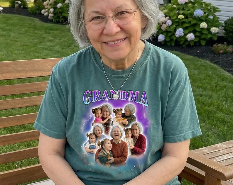 May include: A teal-colored t-shirt with the word "GRANDMA" in a purple and blue font. The shirt features a collage of photos of a woman and children. The woman is wearing glasses and a silver necklace.