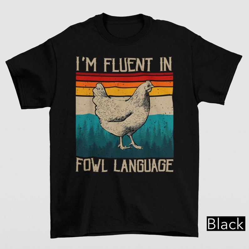 May include: Black t-shirt with a vintage-style graphic of a chicken and the text "I'm fluent in fowl language".