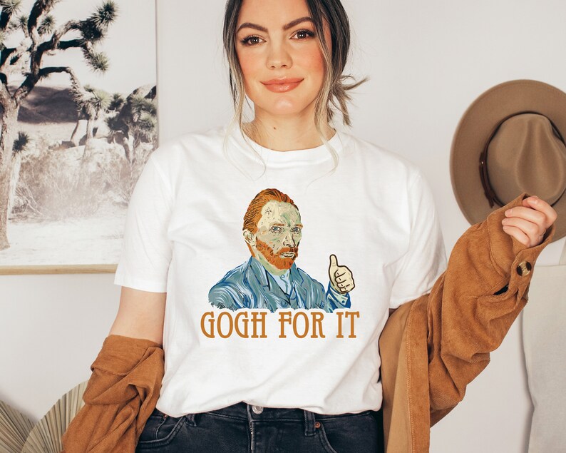 May include: White t-shirt with a colorful illustration of Vincent van Gogh giving a thumbs up. The text "GOGH FOR IT" is printed below the illustration.