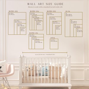 May include: Wall art size guide with dimensions in cm, shown to scale with a 137.16 cm crib. Includes ratios 4x5, 3x4, 2x3, 1x1, and 11x14, plus A1-A4 sizes. A white crib is in the foreground, with a pink chair and pillows.