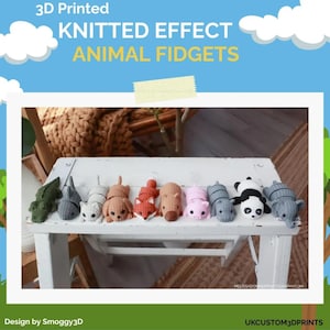 May include: A collection of 3D-printed animal fidgets with a knitted effect, including a green alligator, gray cat, brown dog, red fox, brown hippo, pink pig, gray seal, panda, and gray elephant. The text reads "3D Printed KNITTED EFFECT ANIMAL FIDGETS."
