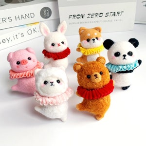 May include: Six felt animal figurines with ruffled collars. The animals are a pig, rabbit, alpaca, bear, Shiba Inu, and panda. The collars are red, pink, white, yellow, blue, and light blue.