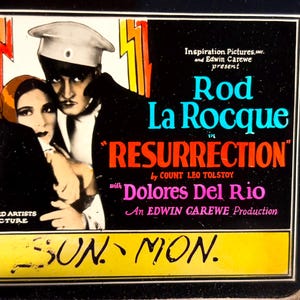 May include: A vintage movie poster advertising the film "Resurrection" starring Rod La Rocque and Dolores Del Rio. The poster features a black and white image of the actors, with a yellow background and red, blue, and white text.