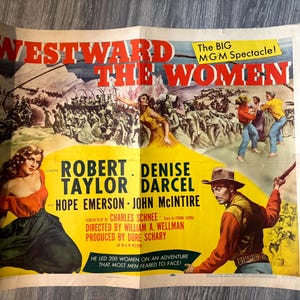 May include: Vintage movie poster for "Westward the Women" with a yellow and red color scheme. The poster features illustrations of actors and scenes from the film, including text that reads "The BIG M-G-M Spectacle!"