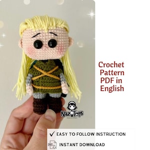 May include: A crocheted doll with blonde hair and a green and brown outfit. The doll has large black eyes and is held in a person's hand. The text "Crochet Pattern PDF in English" is visible. The doll is a Naz Toys product.