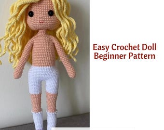 Könnte beinhalten: Eine handgefertigte Häkelpuppe mit hellem Hautton, gelocktem Haar und schwarzen Augen. Die Puppe trägt weiße Shorts und Socken, mit einem pfirsichfarbenen Oberkörper und Beinen. Der Text "Easy Crochet Doll Beginner Pattern" ist sichtbar.