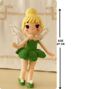 May include: A crocheted fairy doll with yellow hair, green dress, and white wings. The doll is 27 inches tall.