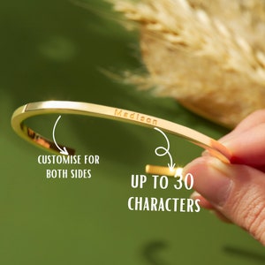May include: Gold-toned bangle bracelet with the name "Madison" engraved on the front. The bracelet can be personalised with up to 30 characters on both sides.