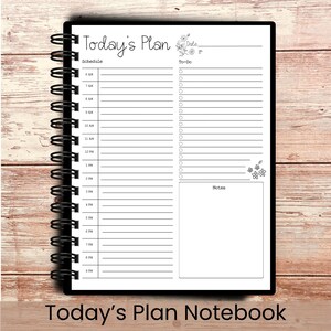 May include: A black spiral-bound notebook with a white interior. The notebook is labeled "Today's Plan" and includes sections for scheduling, to-do lists, and notes. The bottom of the notebook reads "Today's Plan Notebook".