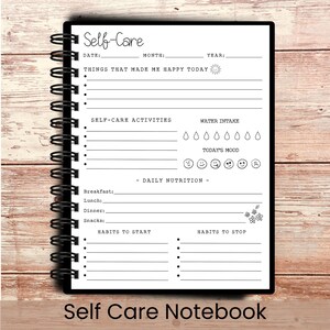 May include: A black spiral-bound notebook with the words "Self-Care" at the top. The notebook's pages include sections for daily entries, including mood tracking, water intake, and habits to start and stop. The words "Self Care Notebook" are at the bottom.