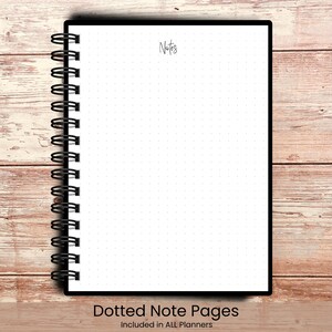 May include: A black spiral-bound notebook with white dotted pages. The word "Notes" is written in cursive at the top. The bottom of the notebook reads "Dotted Note Pages Included in ALL Planners". The notebook is on a wooden surface.